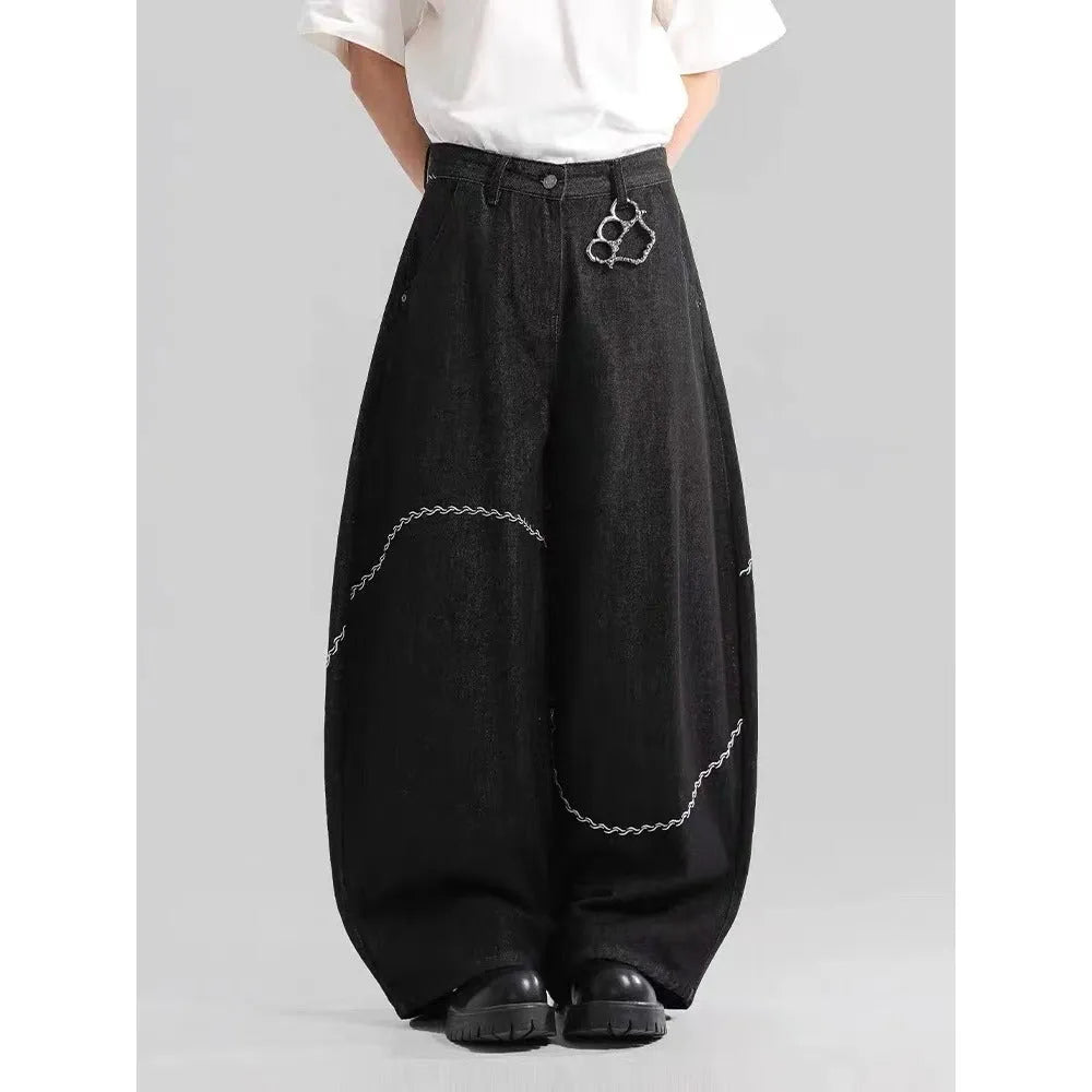 Black straight-leg denim trousers with a mid-waist fit and micro-elastic waistband on a hanger.