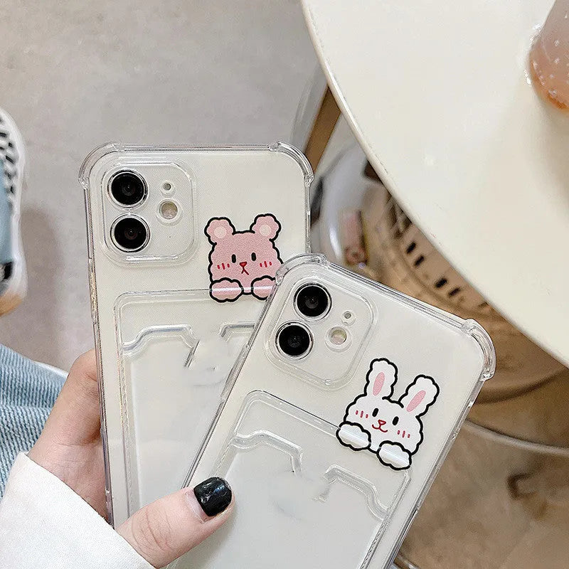 Transparent iPhone case with cartoon design and built-in card holder slot on the back.