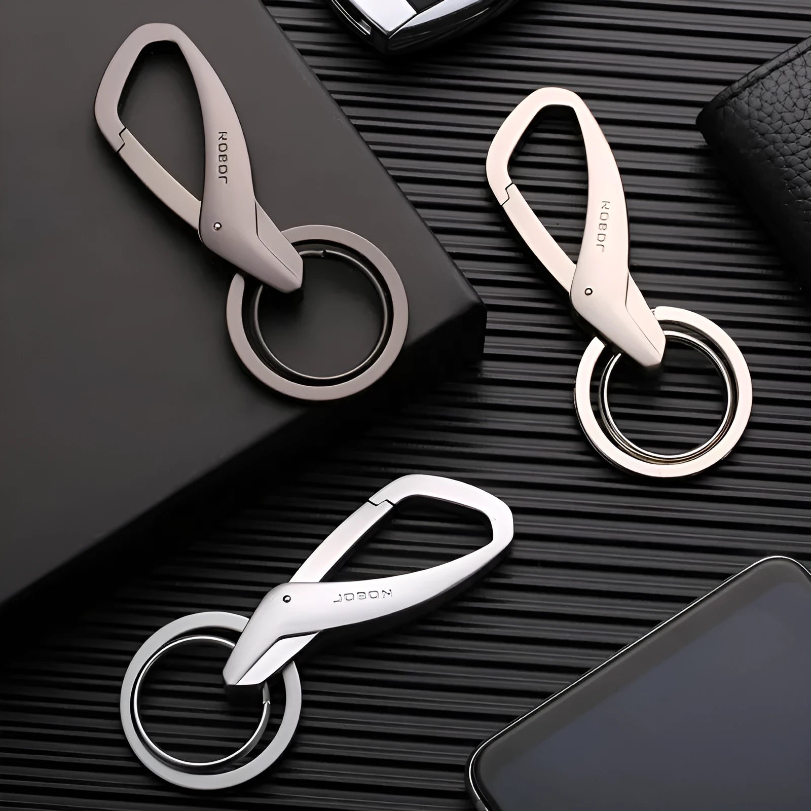 Black zinc alloy double ring keychain for car keys, shown attached to a belt loop.