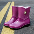 Women's purple PVC rain boots with non-slip sole and middle tube height