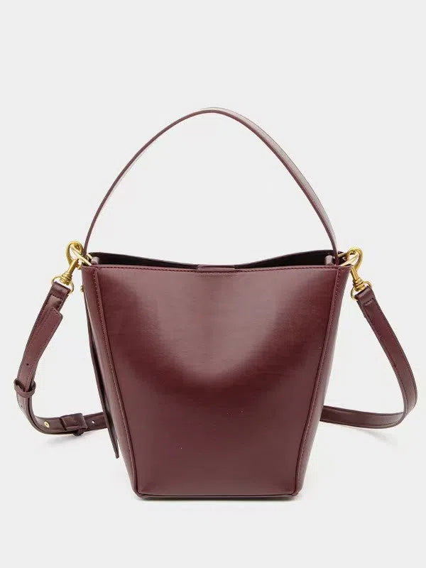 Urban minimalist bucket-style crossbody shoulder bag in PU with three-dimensional outer pocket, black colour option, flat lay view