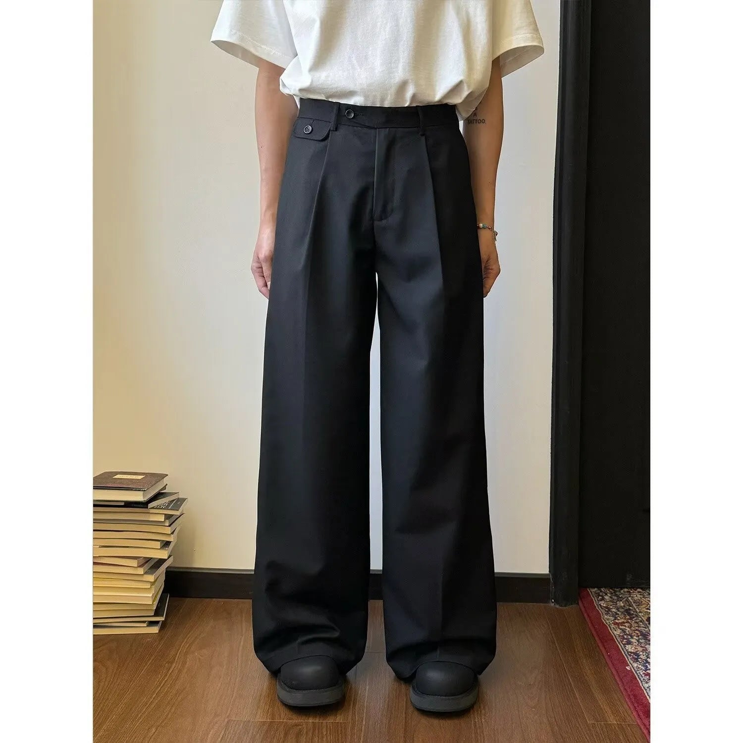 Men's brown straight-leg casual trousers with a loose wide-leg cut on a neutral background.