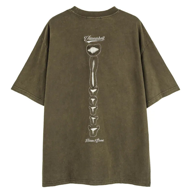 Man's brown loose-fit T-shirt with a skull and letter graphic print on the front, featuring drop-shoulder sleeves.
