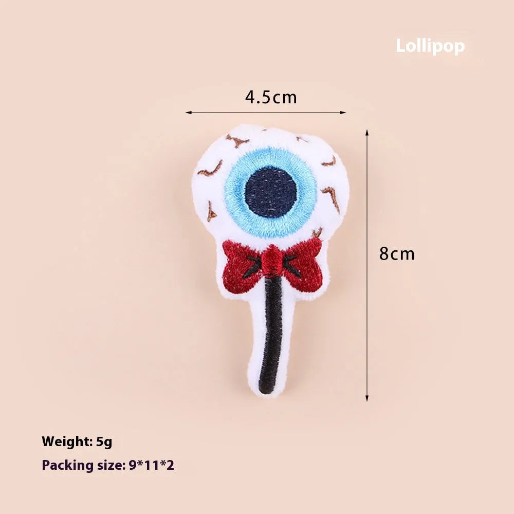 Small colourful plush cat teaser wand with candy, eyes, and skull designs
