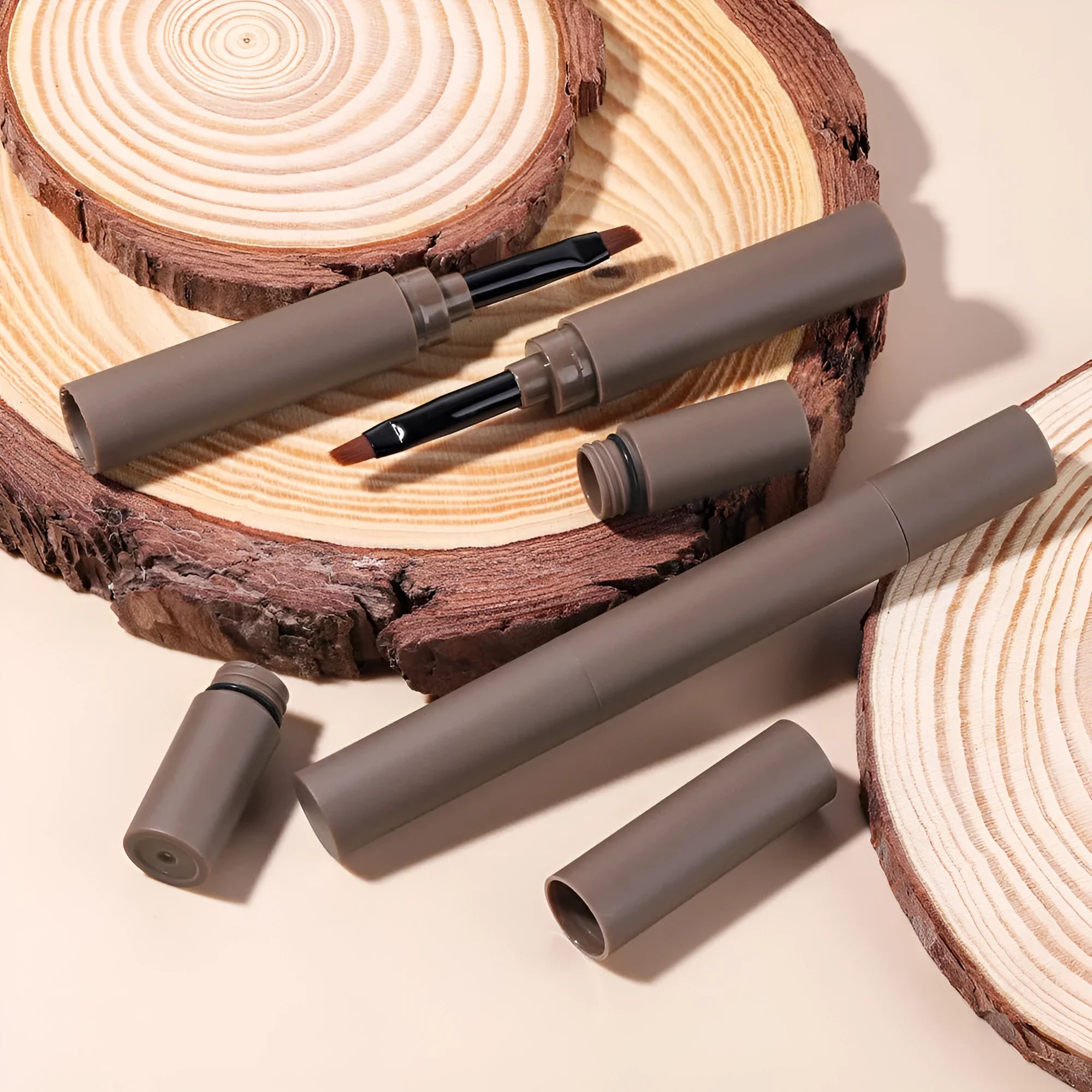 Double-headed eyebrow cream tube showing five shade options: reddish brown, brown, light brown, dark brown, and black.