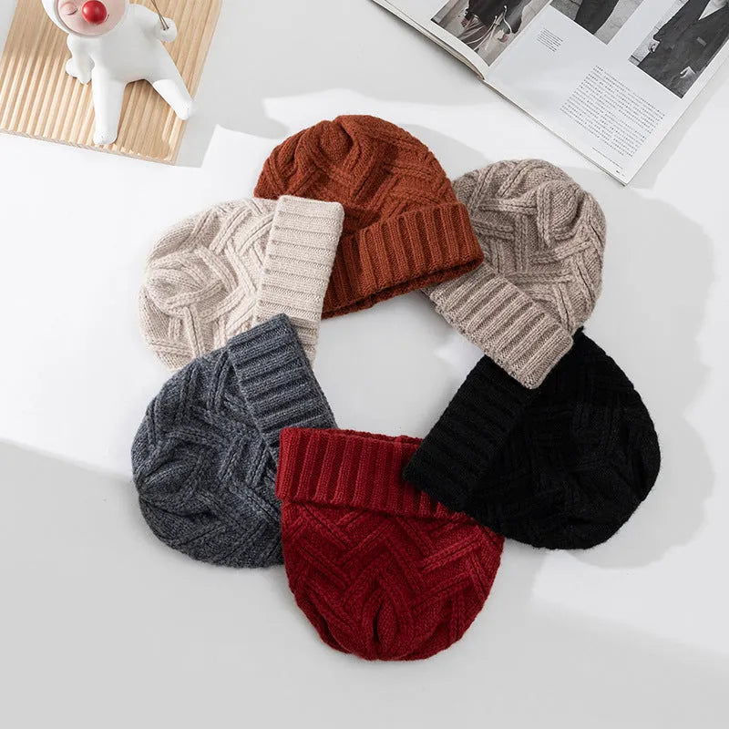 A woman's wool knitted winter hat in a dome crown style, shown in ankela red colour.