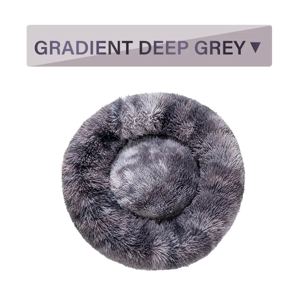 A fluffy, round donut-shaped dog bed with a raised rim in long plush fabric.