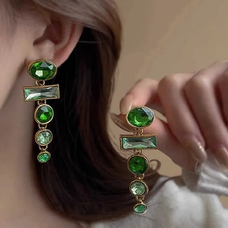 Retro green gradient geometric stud earrings with long silver tassel drop on a white background.