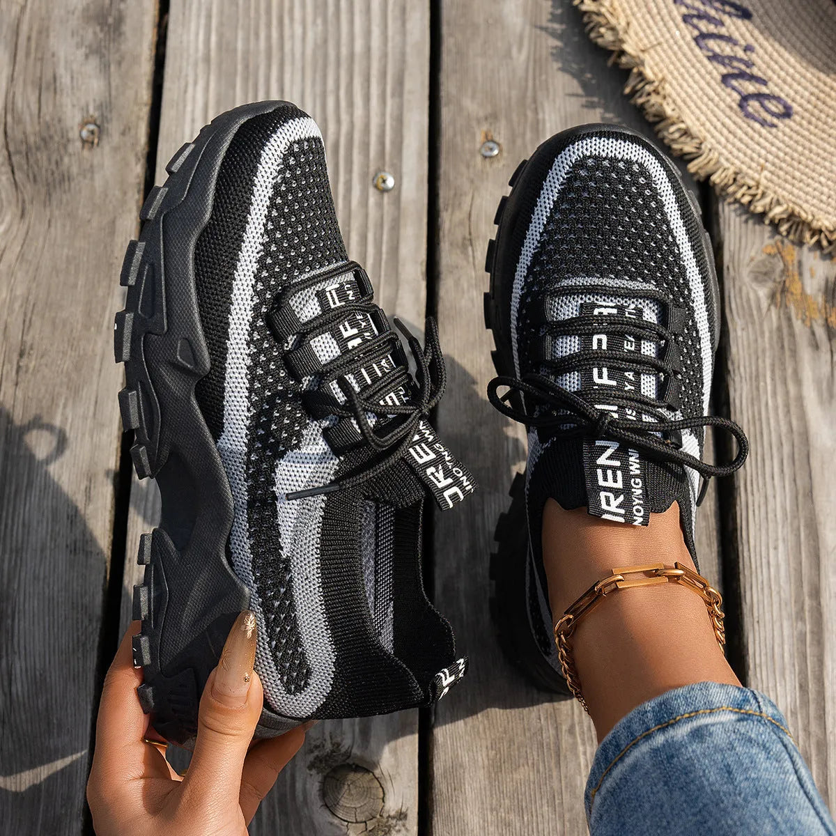 Women's Flyknit mesh lace-up sneakers in various colours with a round toe and rubber sole.