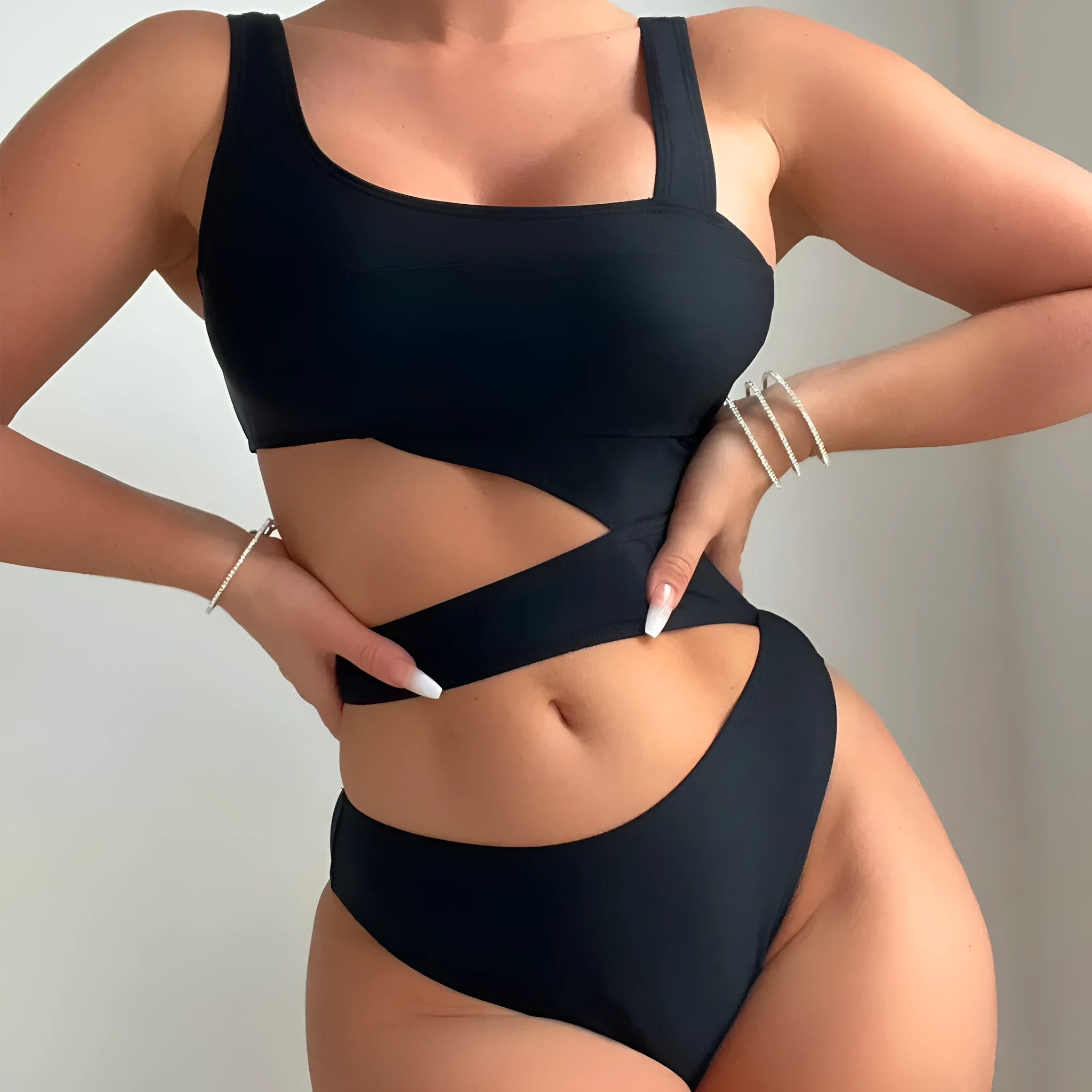 A solid black women's one-piece swimsuit with a high cut leg design on a mannequin.