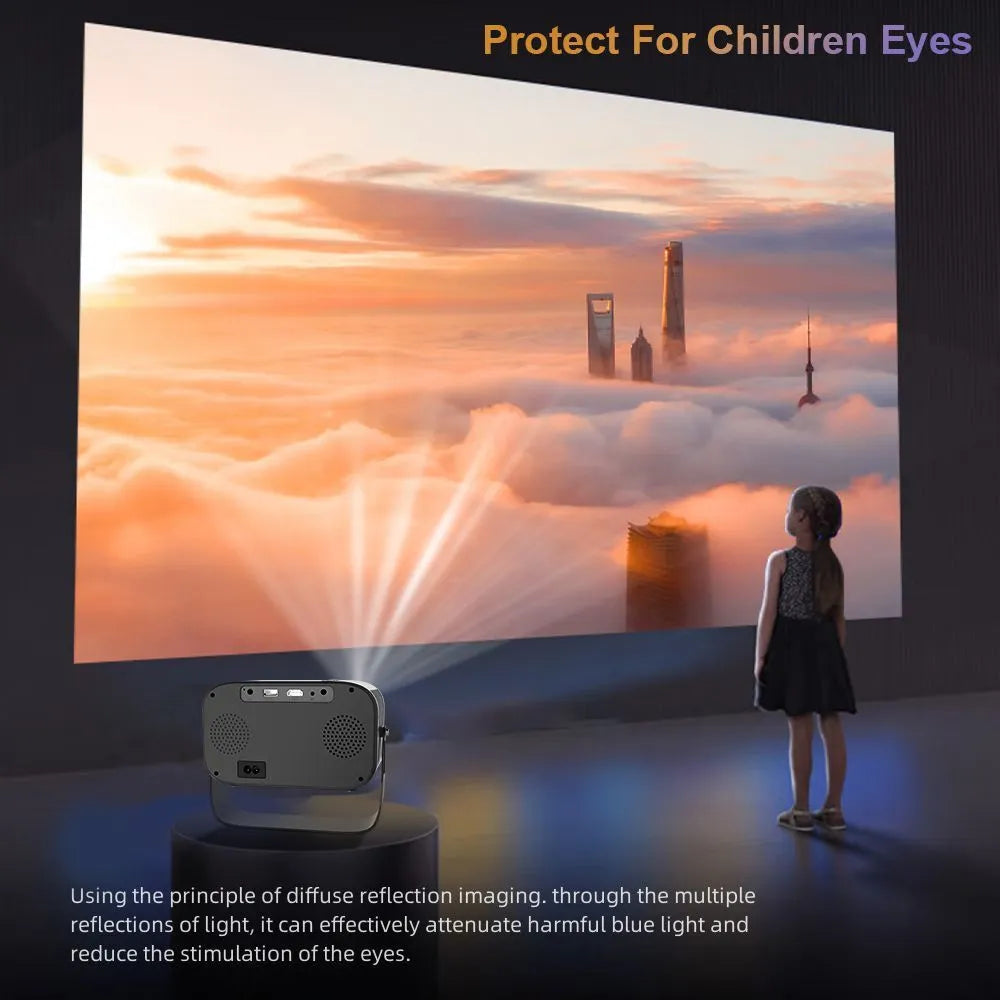Black portable smart HD projector with remote control on a desk.