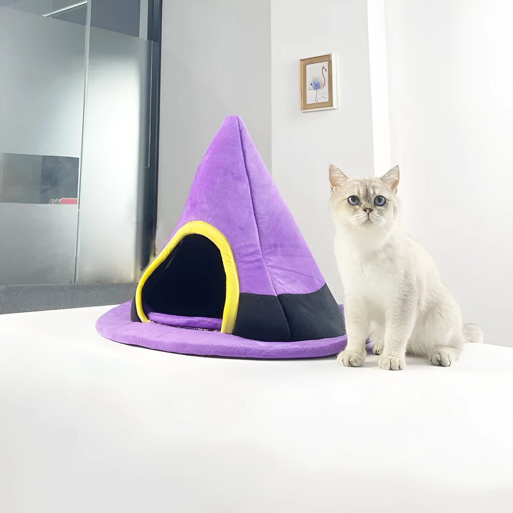 Purple Halloween witch hat shaped cat bed for pets, showing soft cloth material and enclosed design.