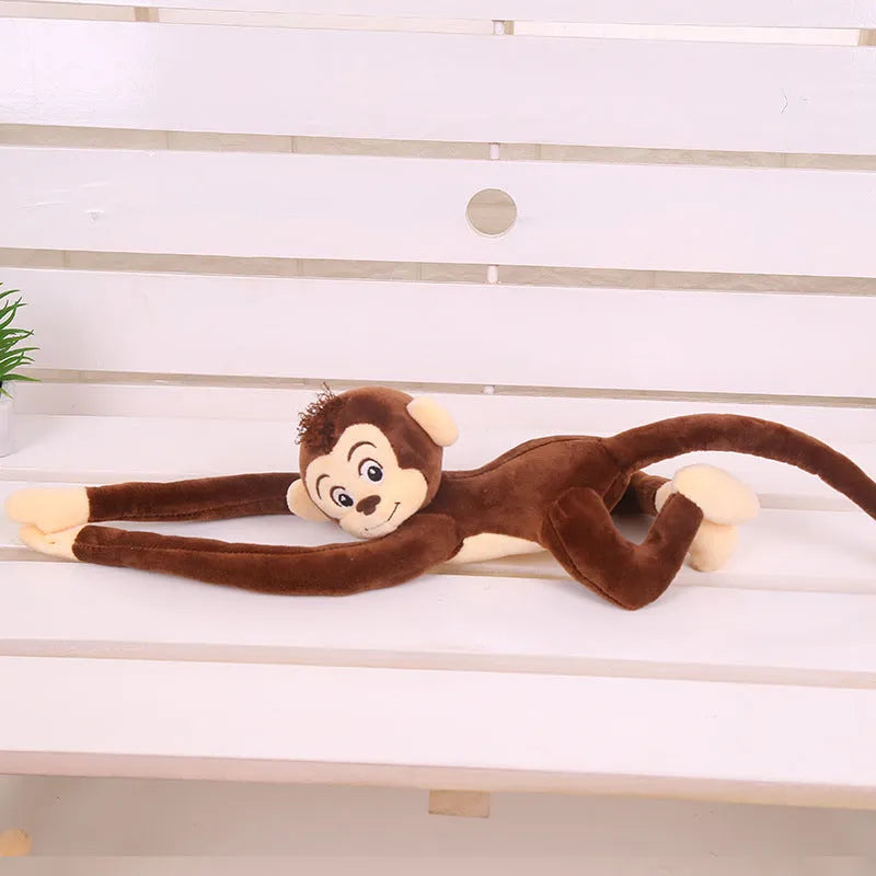Long arm hanging monkey plush toy in pink, 70cm height, curled around a curtain rod for home decoration