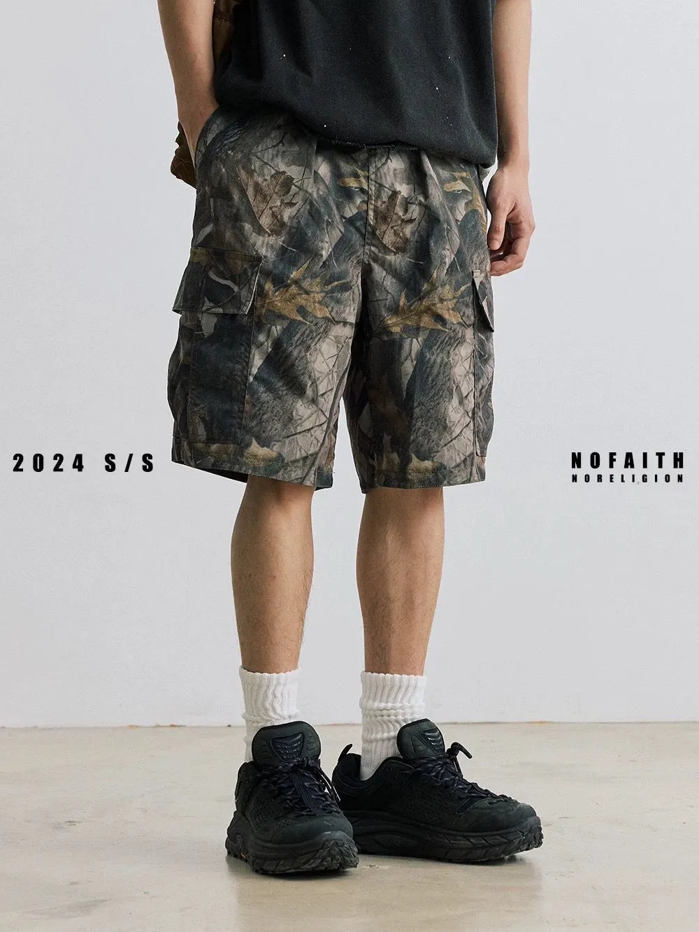 Loose casual straight-leg denim shorts in black on a hanger, showing mid waist and zip fly.