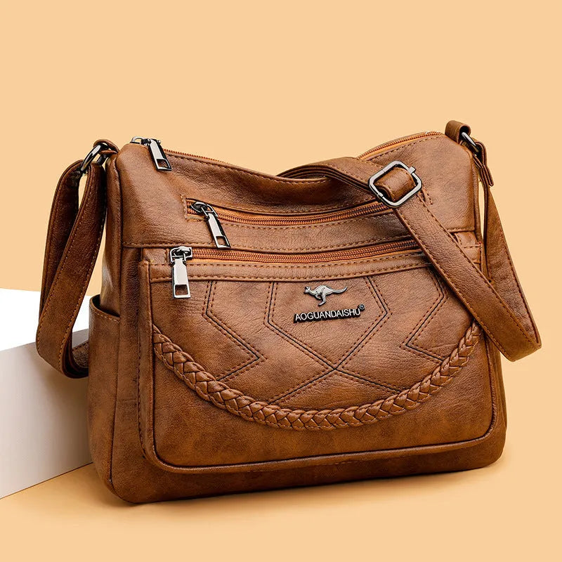 Soft black PU leather women's crossbody shoulder bag with a square shape on a white background.