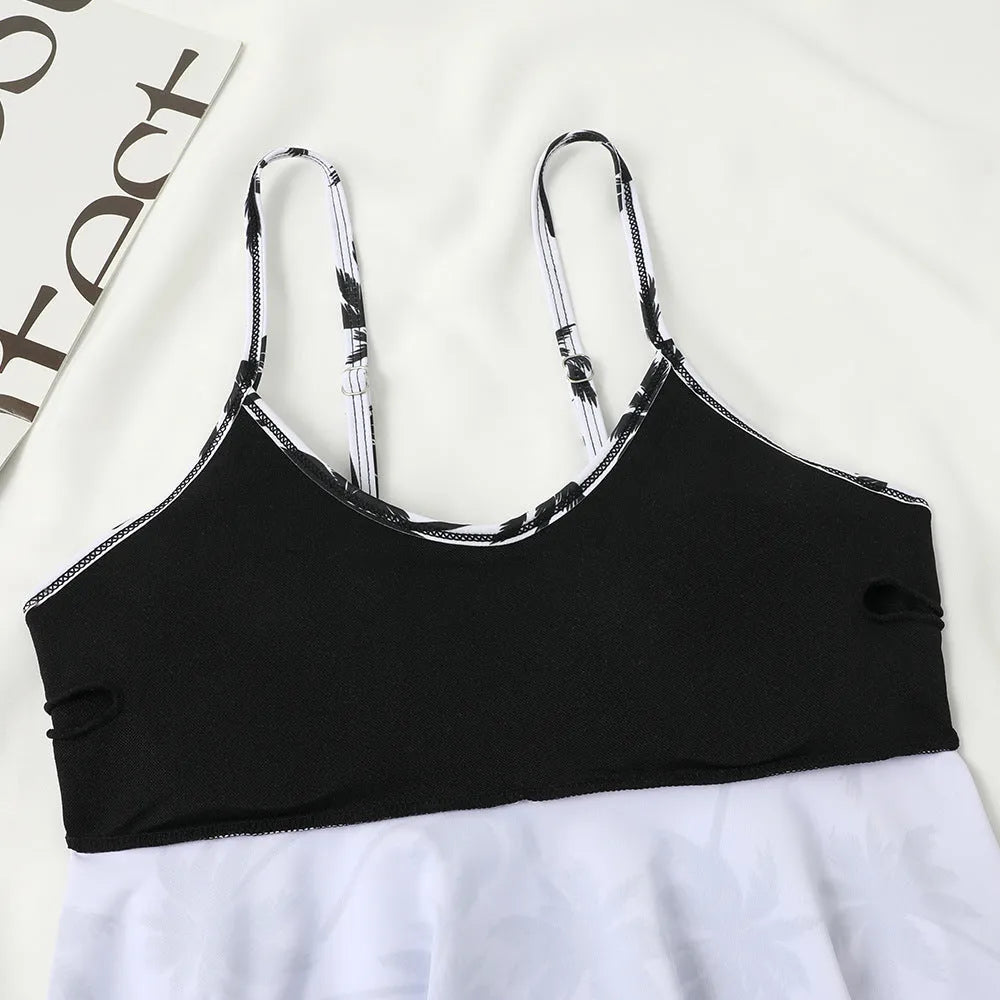 Black high-waist swimsuit briefs with a double-layer front and a matching sleeveless top on a mannequin.