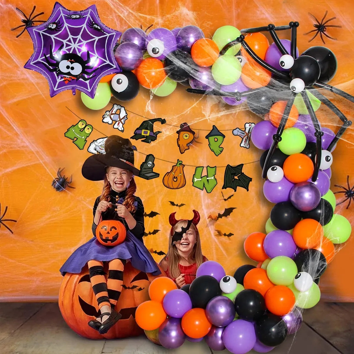 Black and white Halloween balloon arch with spider web, skull, and pumpkin designs