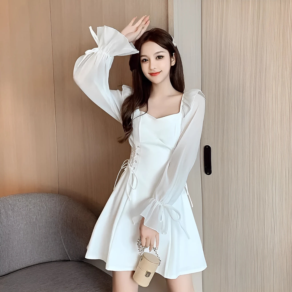 White waist-slimming chiffon patchwork dress with long sleeves on a woman.