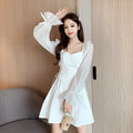 White waist-slimming chiffon patchwork dress with long sleeves on a woman.