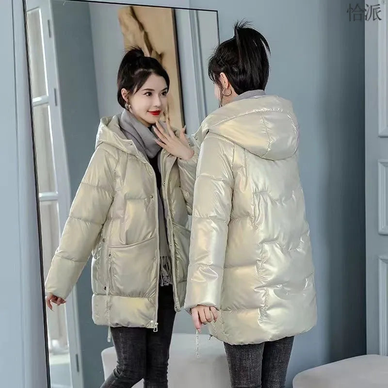 A woman wearing a green ultra-thin hooded winter jacket with long sleeves, showing the front design.