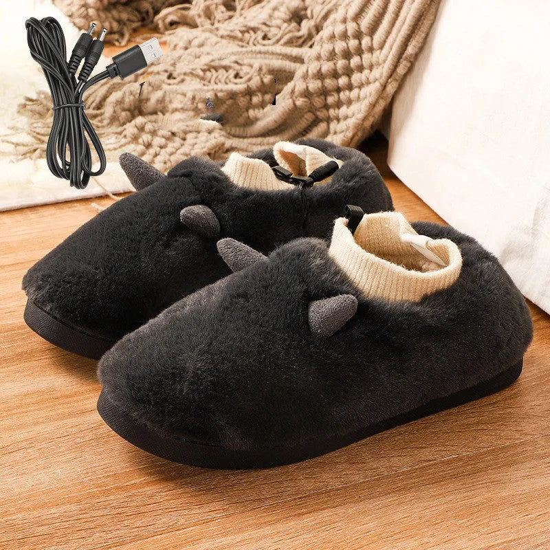 USB electric foot warmer slippers in grey with a connected USB cable on a wooden floor.