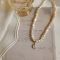French Court style vintage pearl necklace with geometric alloy pendant on an adjustable chain.
