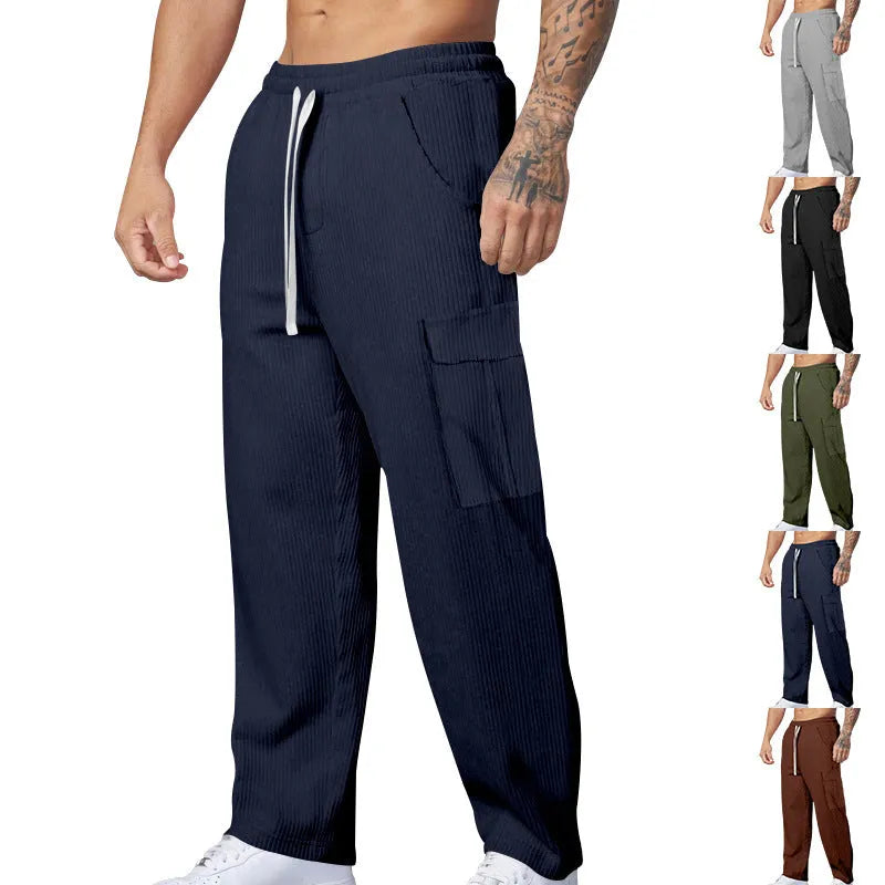 Men's straight-leg corduroy trousers in navy blue, showing loose fit and drawstring waist detail.