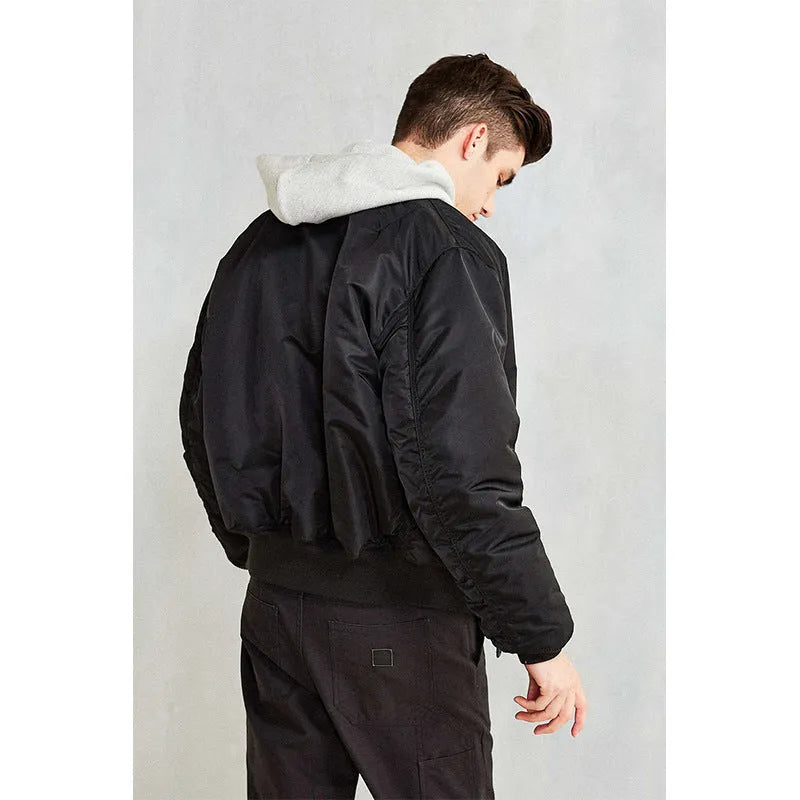 Men's army green cotton-padded pilot jacket with double-sided nylon construction on a hanger.
