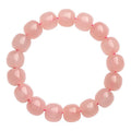 Pink natural crystal bracelet with 8x10mm barrel-shaped beads on a cord.