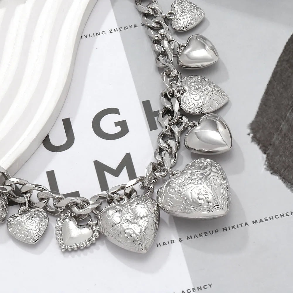 Gold carved heart-shaped pendant necklace on an adjustable metal chain.