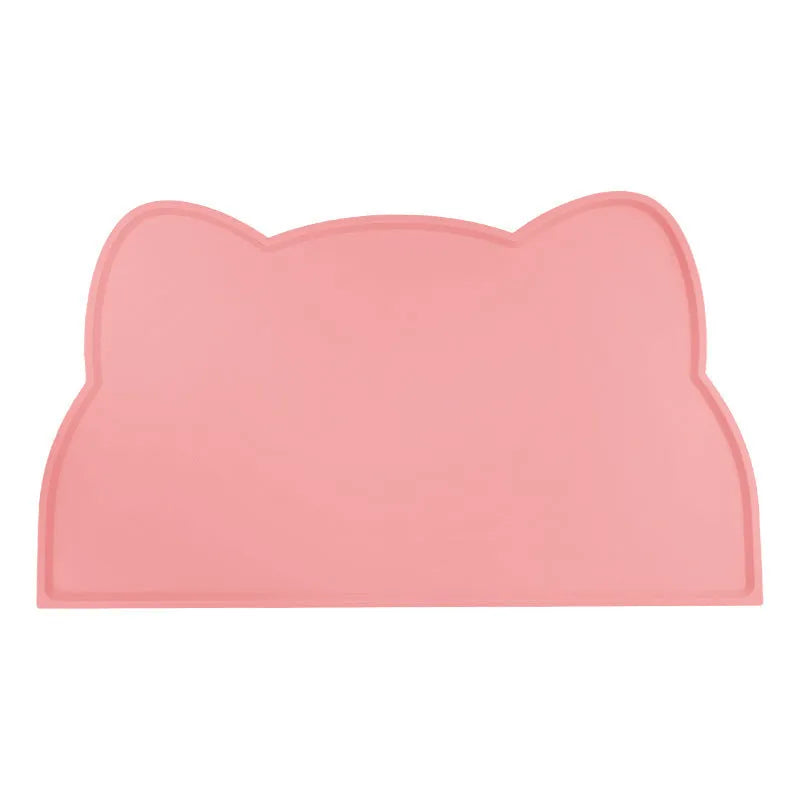 Blue silicone pet feeding mat for dog or cat bowls on a wooden floor.