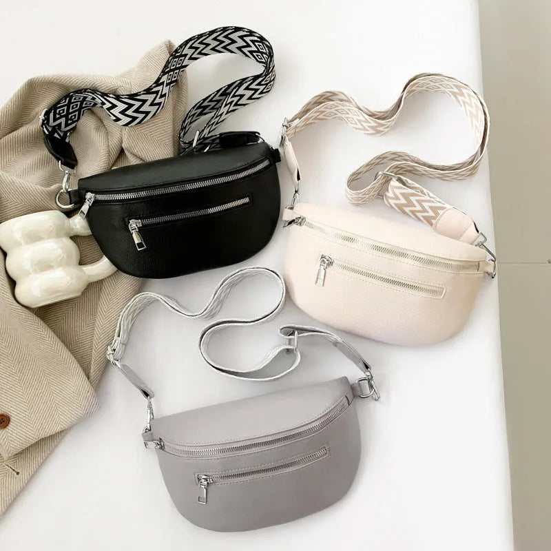 Soft PU leather oval shoulder crossbody bag, 24.5 x 14.5 x 8 cm, with single strap and slit pocket.