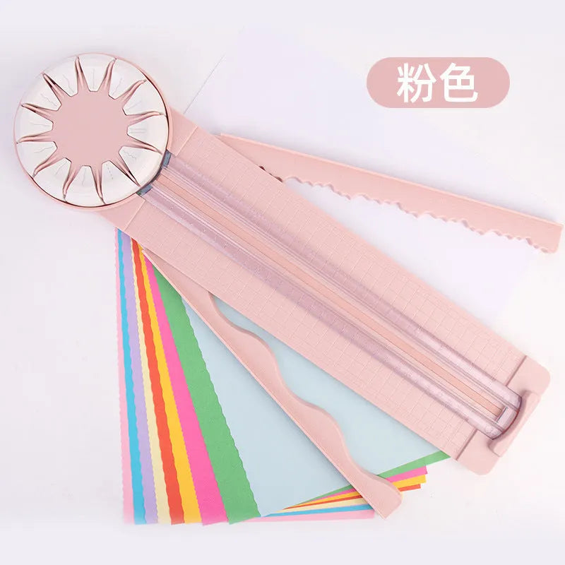 Pink plastic desktop paper cutting machine with a rotary blade for 12 different decorative edge patterns.