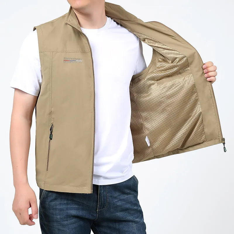 Man wearing a striped khaki waterproof hooded vest coat with multiple patch pockets.