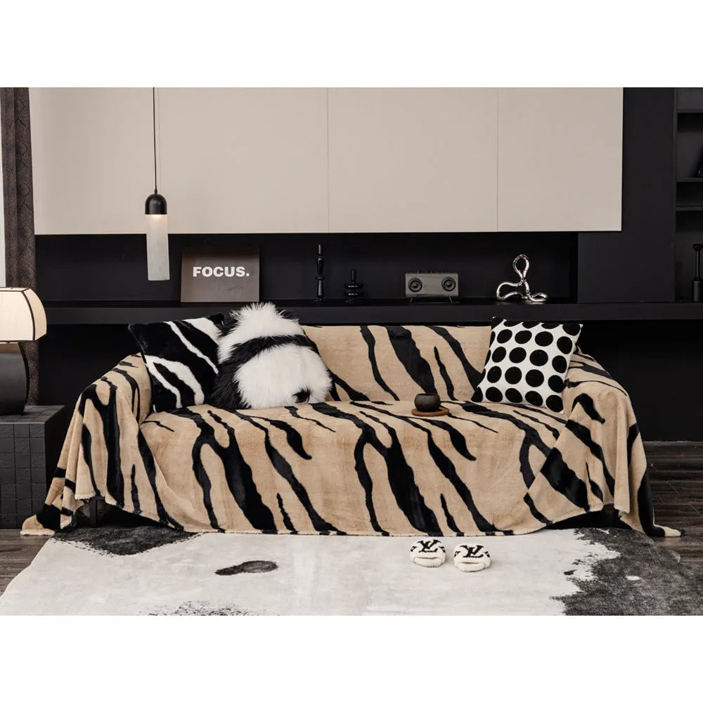 Zebra pattern thickened flannel sofa cover in caramel colour with matching pillowcase on a grey sofa.