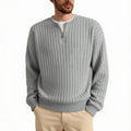 Man wearing a loose grey half-zip textured knit pullover sweater.