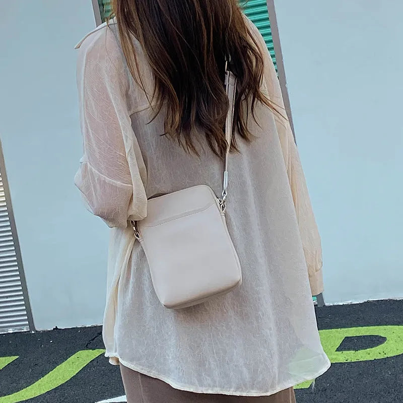Solid colour women's PU crossbody phone bag shown in beige, displaying front view.