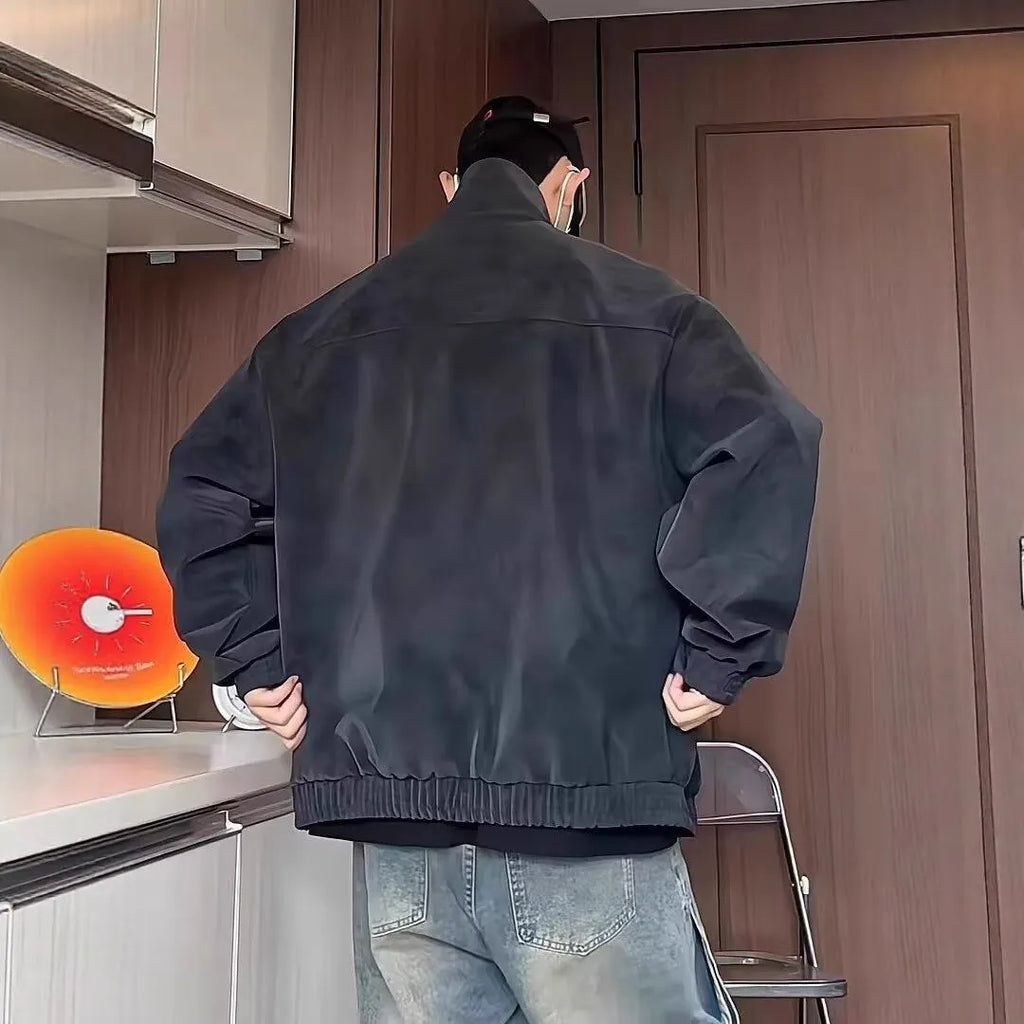Man modelling a grey tie-dyed PU leather jacket with a stand collar and side pockets.