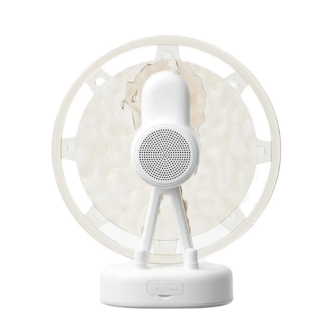 Pink and white Bluetooth speaker projecting colourful Ferris wheel and water ripple LED light patterns