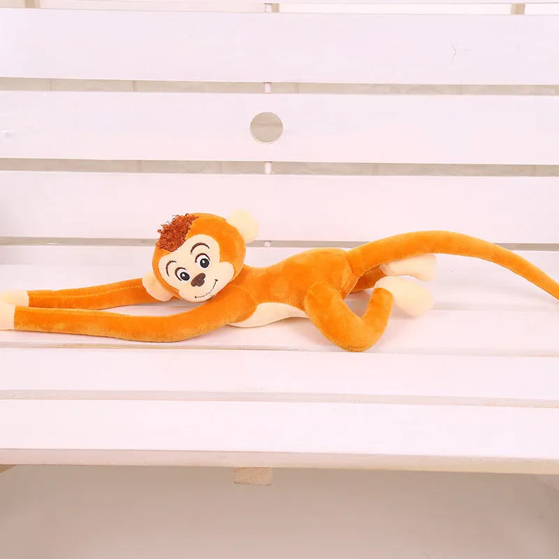 Long arm hanging monkey plush toy in pink, 70cm height, curled around a curtain rod for home decoration