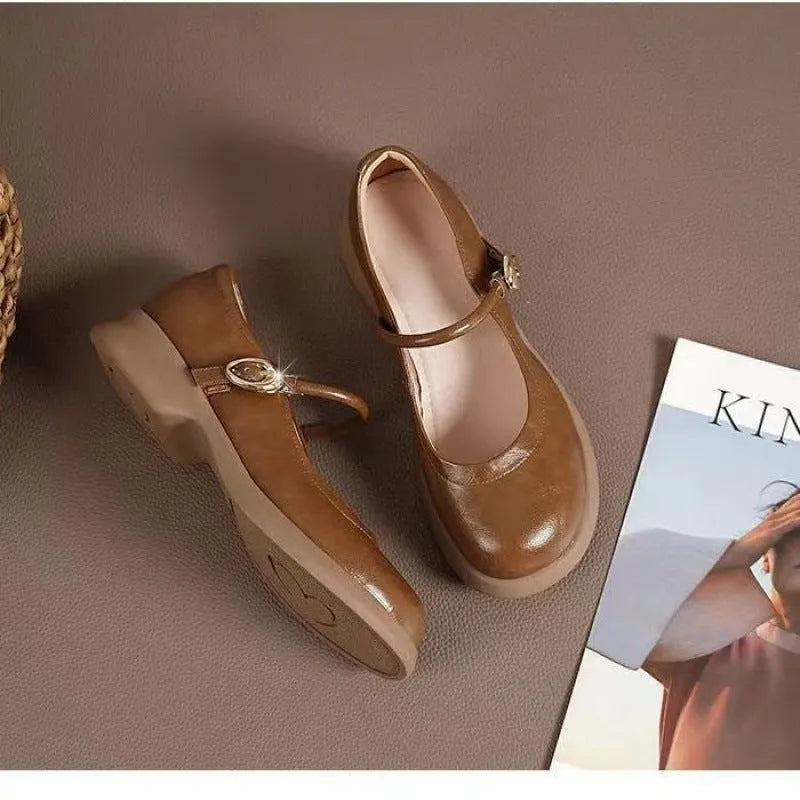 Flat fairy style leather shoes with wedge heel and round toe in black, white, and light brown colours.