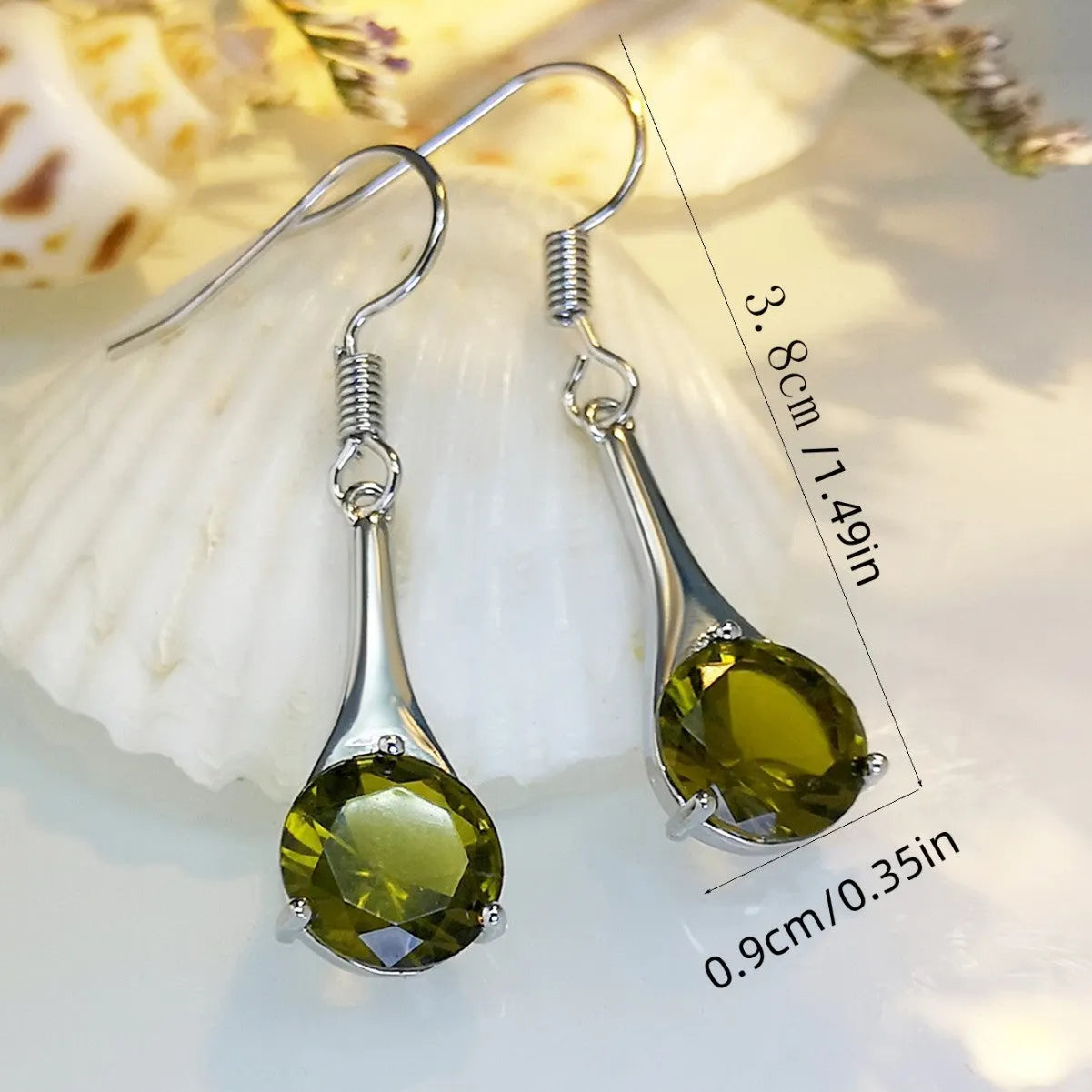 Olive green topaz coloured drop earrings with a water drop shape and retro style on a white background.