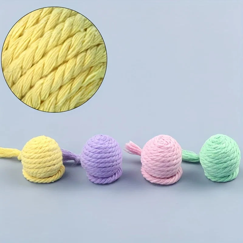 Cat toy ball with rope attachment and bell inside, shown in green, pink, purple, and yellow colour options