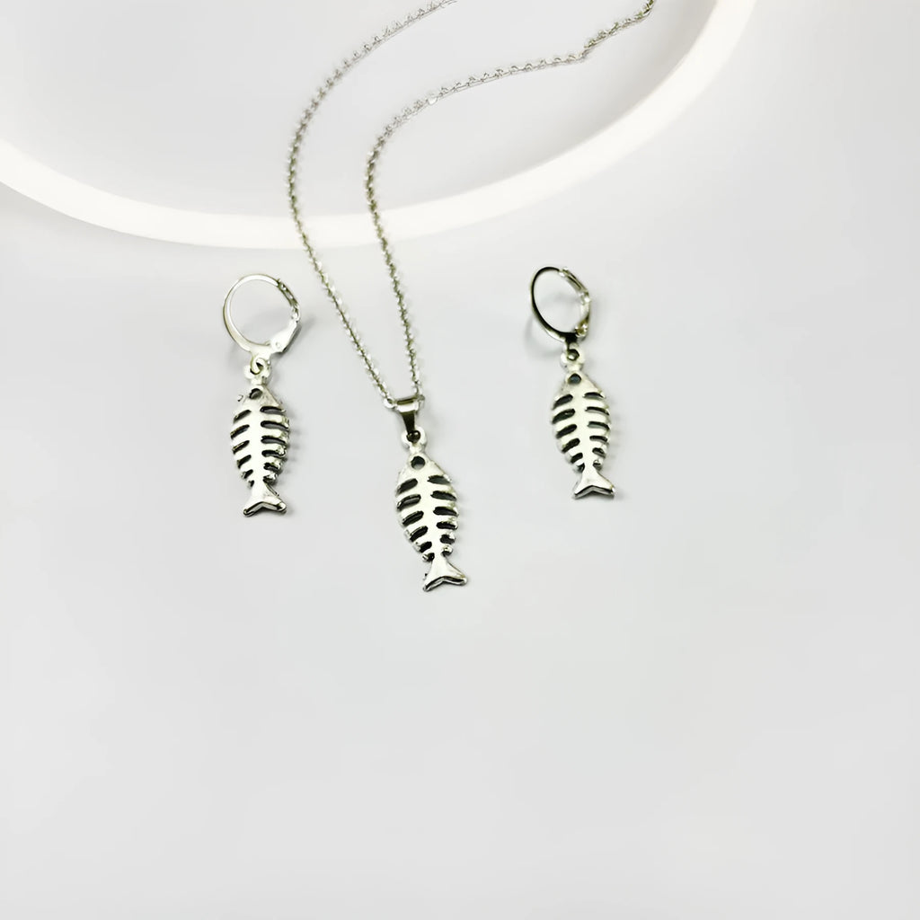 Close-up of retro-style fishbone pendant earrings on an adjustable O-chain.