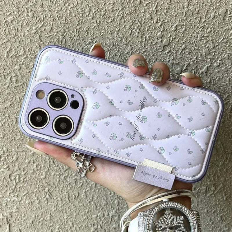 Creative down jacket small floral leather phone case with embossed design for iPhone showing purple background