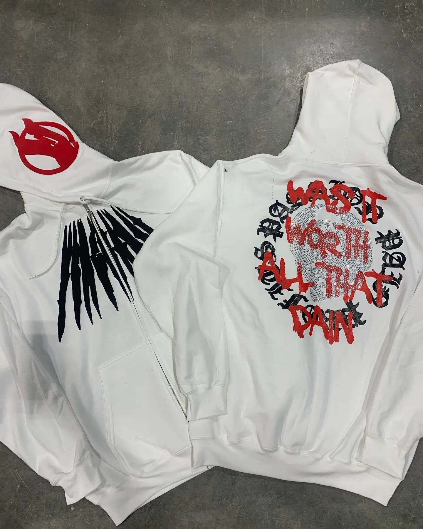 Black hooded sweatshirt with printed skull pattern and rhinestone detailing, cardigan style with loose fit