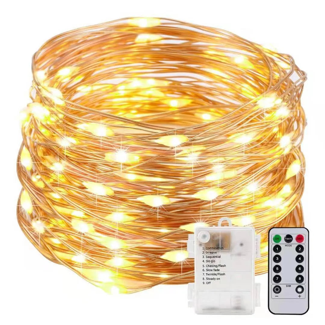Close-up of flexible copper wire fairy lights with warm white LEDs wrapped around a wooden banister