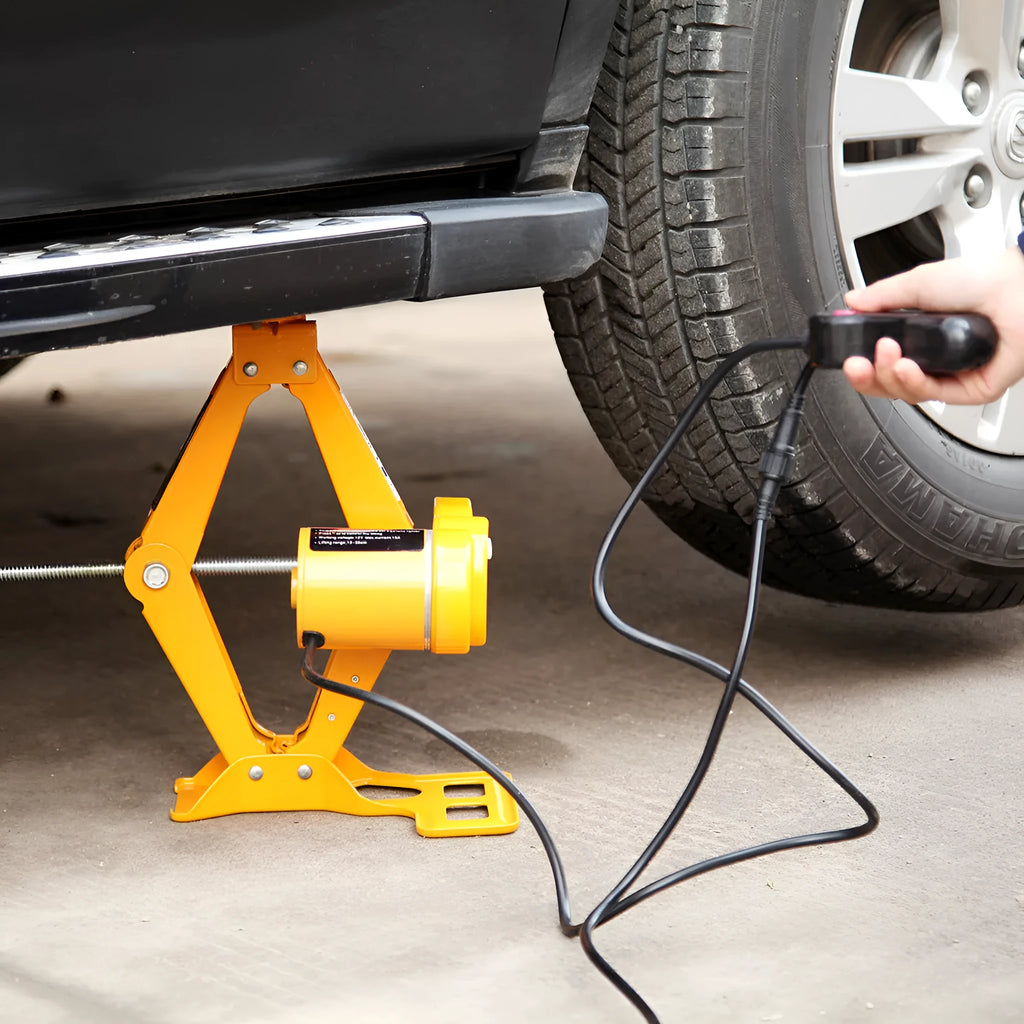 Hydraulic electric car jack kit with control box, shown stored in a vehicle boot.
