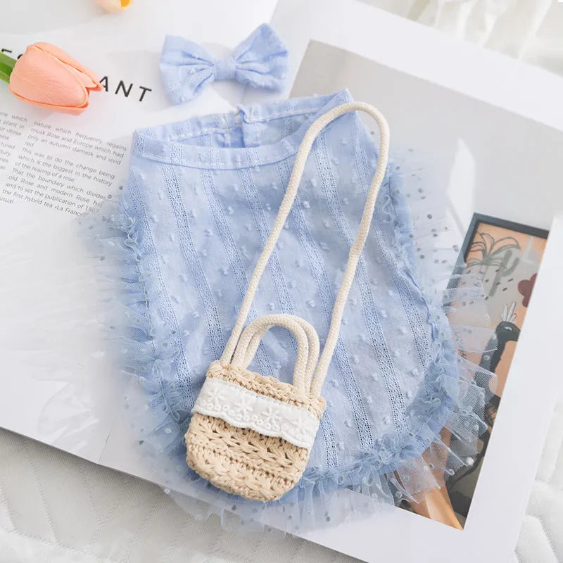 Two-tone sleeveless pet outfit in yellow or blue with ruffles, matching bow and small woven crossbody bag.