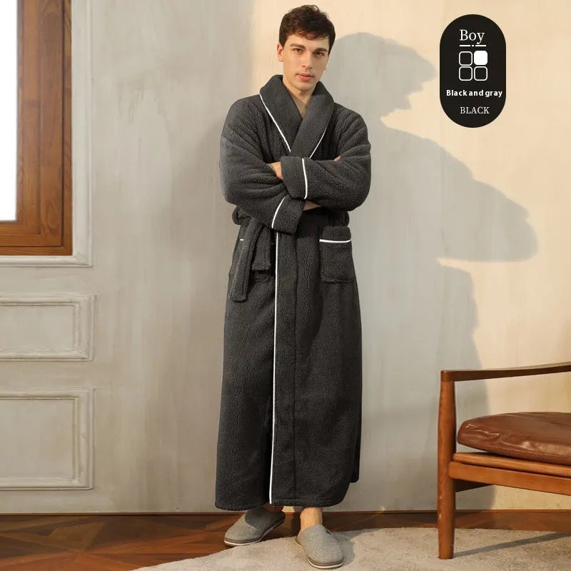 A man and woman wearing matching navy blue thick flannel bathrobes, showcasing the wrap-around design and plush fabric.